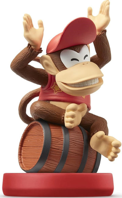 Diddy Kong amiibo figure from Nintendo’s Super Mario series, sitting on a barrel with arms raised in a joyful pose, wearing red cap and star shirt on red base.